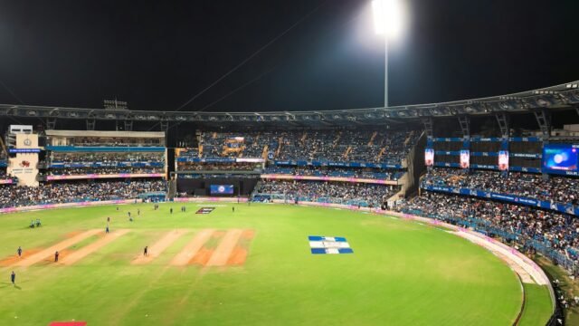 A floodlit cricket ground during a T20 match