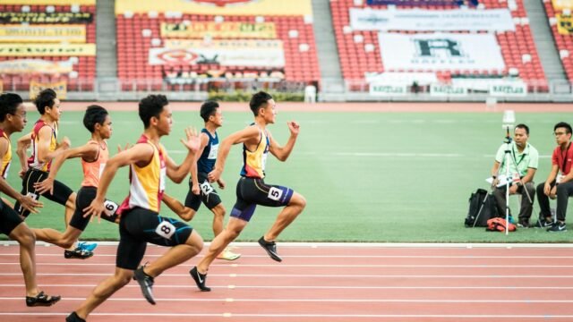 Runners racing on a stadium track